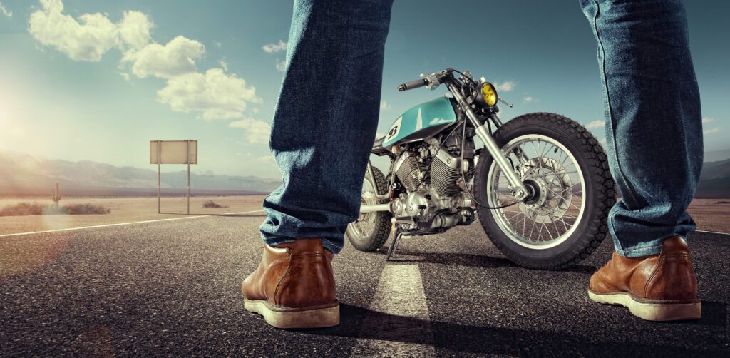 Sport. Biker Standing Near The Motorcycle On An Empty Road